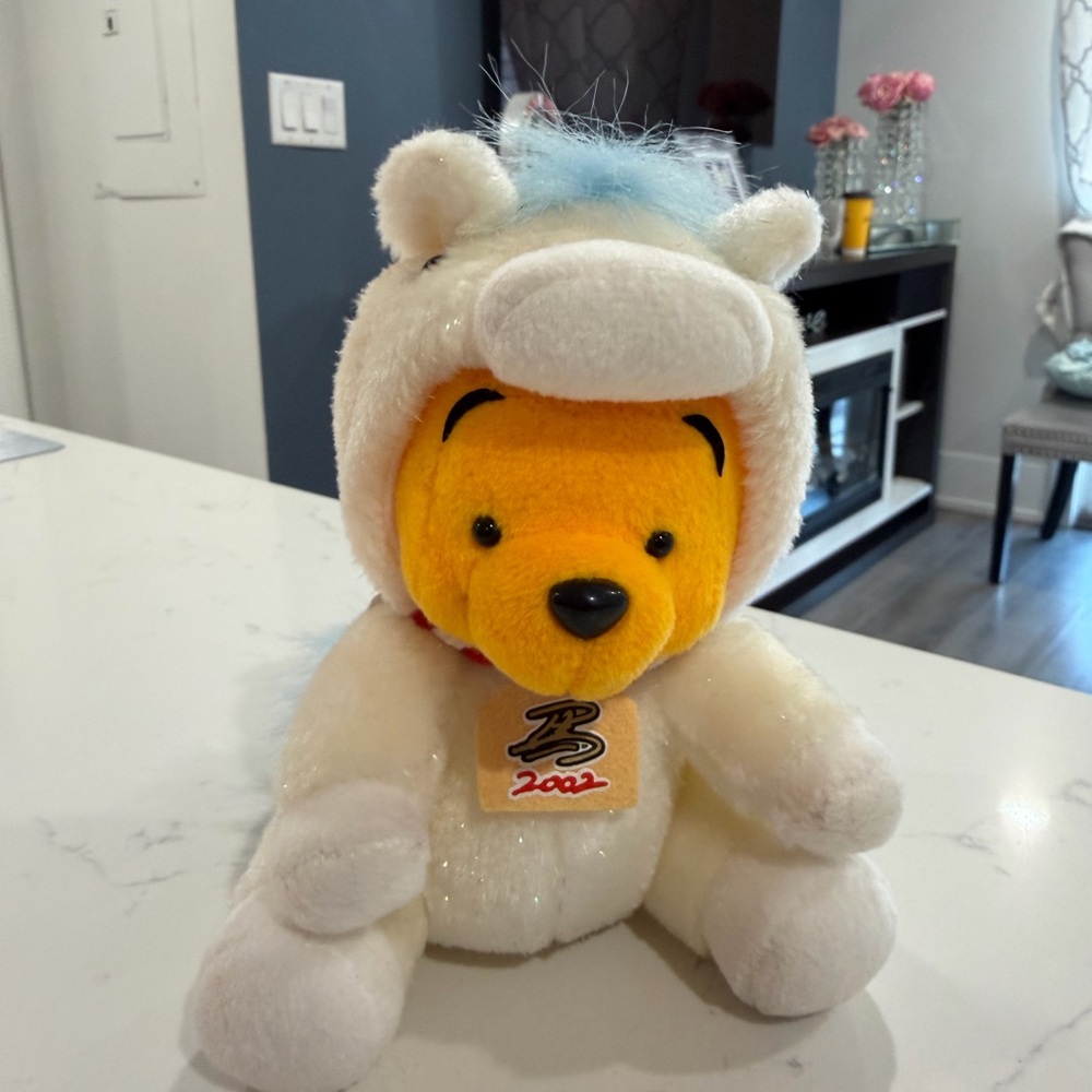 This is a Disney Winnie-the-Pooh plush toywith a unicorn costume, 🦄